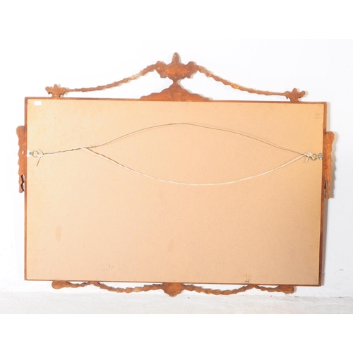 1052 - A 20th Century French style bevelled overmantle mirror of rectangular form having gilt frame with sw... 