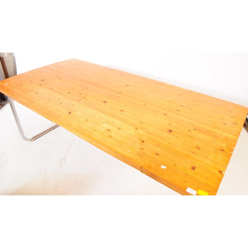 618 - A contemporary pine wood folding kitchen dining trestle table. The table raised on folding metal tre... 