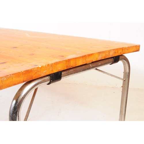 618 - A contemporary pine wood folding kitchen dining trestle table. The table raised on folding metal tre... 