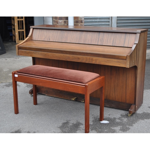 628 - Kimball - A mid 20th century Kimball piano in a walnut veneer case. The piano alongside long teak du... 