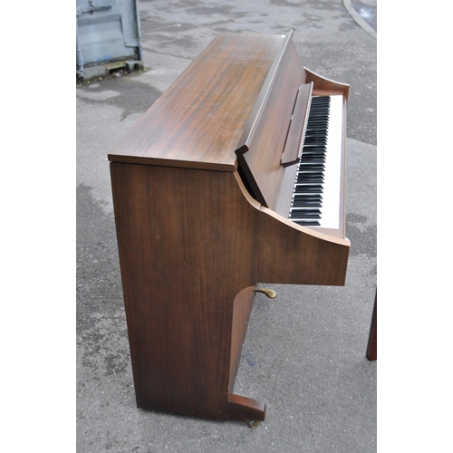 628 - Kimball - A mid 20th century Kimball piano in a walnut veneer case. The piano alongside long teak du... 