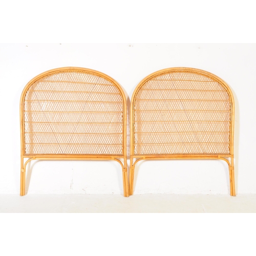 713 - A pair of mid 20th century wicker and bamboo demilune bed headboards. The headboards featuring wicke... 