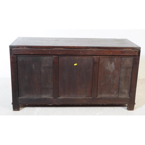 919 - A late 19th century Jacobean revival oak wood coffer chest. The chest raised on block feet with a tr... 