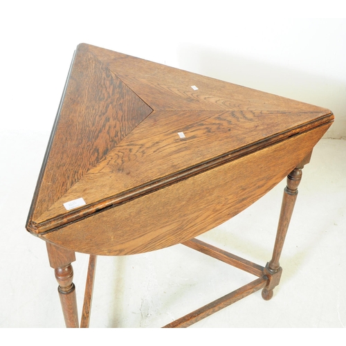 1033 - An early 20th century oak wood drop side cricket / side table. The table raised on a trio of support... 