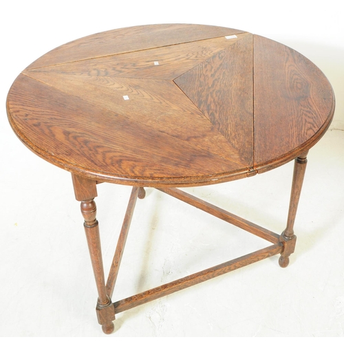 1033 - An early 20th century oak wood drop side cricket / side table. The table raised on a trio of support... 