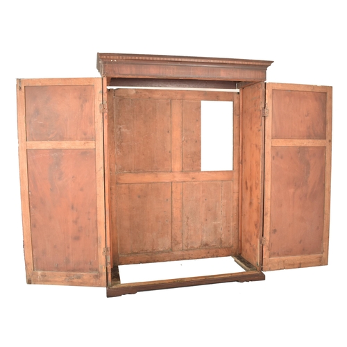 880 - A large early 20th century George III double mahogany wardrobe. Having a carved cornice to top, twin... 