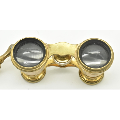 21 - A pair of late 19th century French mother of pearl and gilt brass opera glasses. The glasses complet... 