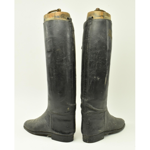 22 - A pair of vintage 20th century black leather riding boots with shoe trees to each. Each measures app... 