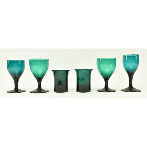 49 - A collection of four assorted early 19th century green glass wine glasses of varying sizes, along wi... 