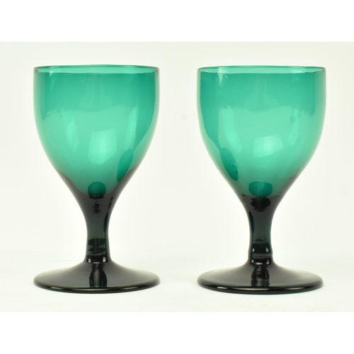 49 - A collection of four assorted early 19th century green glass wine glasses of varying sizes, along wi... 