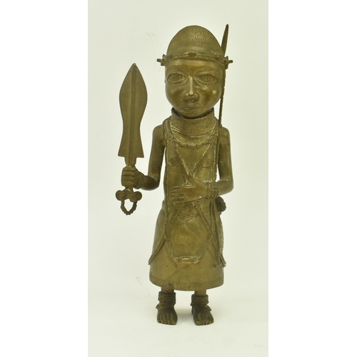 62 - A 20th century African Benin bronze cast figure of a native warrior. The figure wearing a coral bead... 