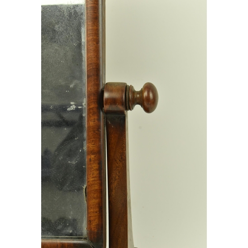 595 - A George III 19th century mahogany toilet swing mirror. The mirror having splayed supports over a ba... 