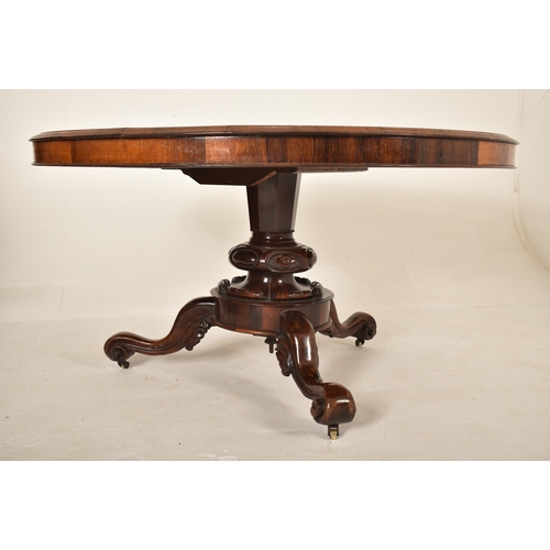 606 - A 19th century Victorian rosewood centre table / breakfast loo table. The table having a rounded top... 