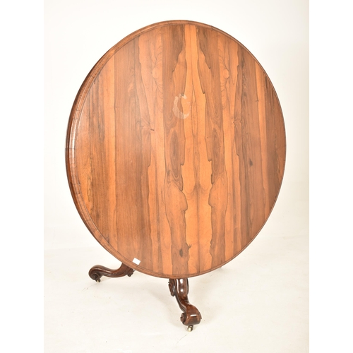 606 - A 19th century Victorian rosewood centre table / breakfast loo table. The table having a rounded top... 