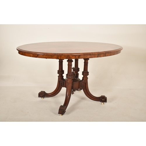 608 - A 19th century High Victorian walnut oval tilt top loo / breakfast table. The table being raised on ... 