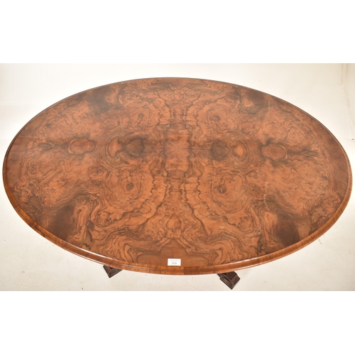 608 - A 19th century High Victorian walnut oval tilt top loo / breakfast table. The table being raised on ... 