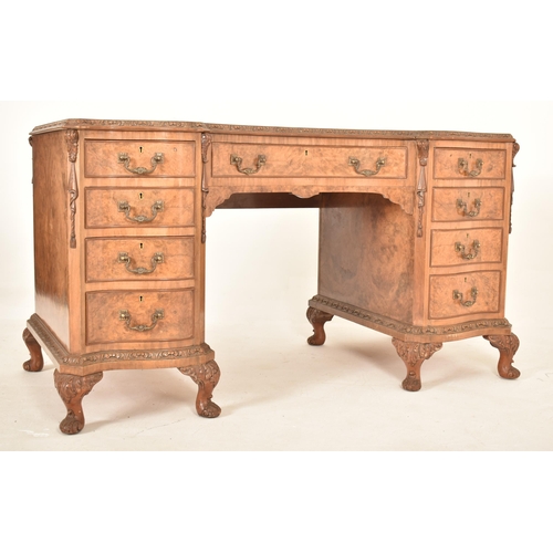 609 - George II revival inverted breakfront walnut twin pedestal desk. The desk of serpentine form with a ... 