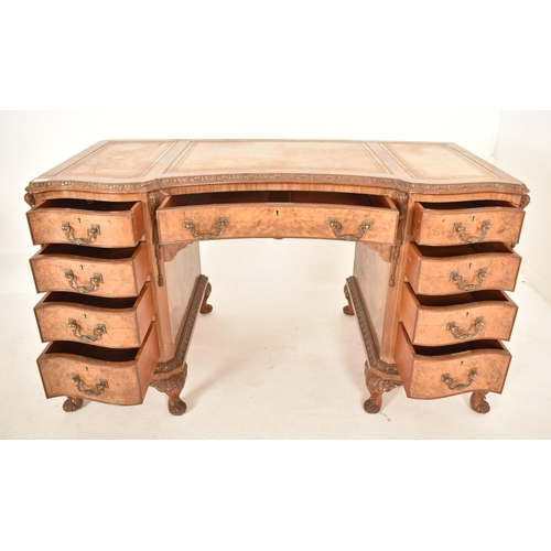 609 - George II revival inverted breakfront walnut twin pedestal desk. The desk of serpentine form with a ... 