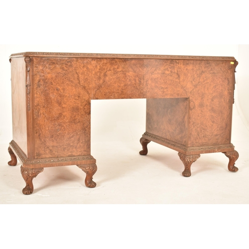 609 - George II revival inverted breakfront walnut twin pedestal desk. The desk of serpentine form with a ... 