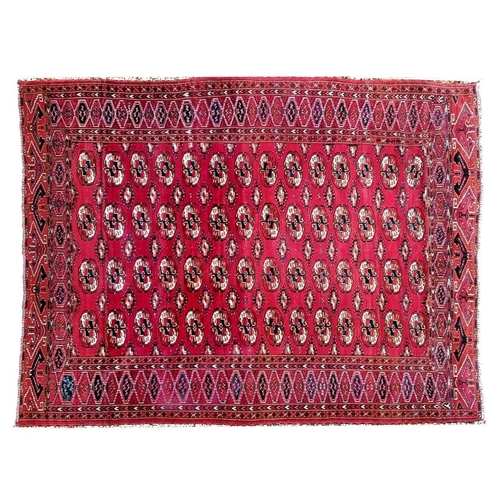 611 - A large 20th century hand knotted Persian Islamic carpet floor rug. The rug having a deep red ground... 