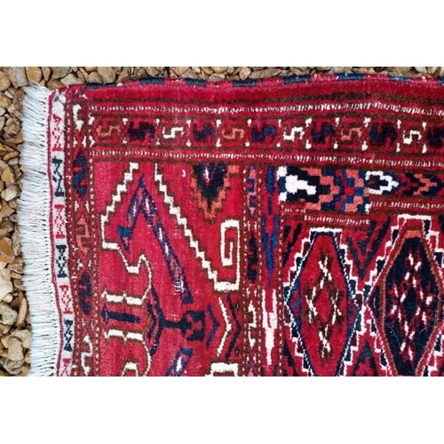 611 - A large 20th century hand knotted Persian Islamic carpet floor rug. The rug having a deep red ground... 