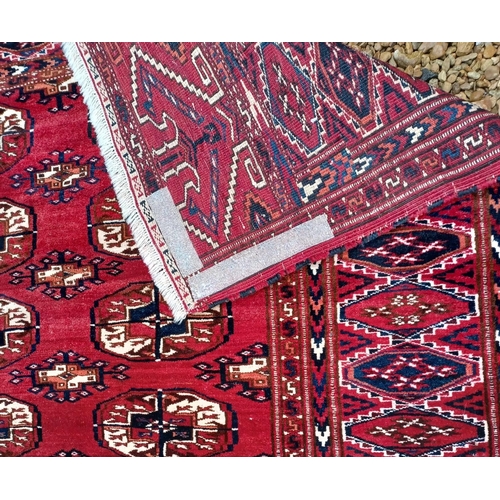 611 - A large 20th century hand knotted Persian Islamic carpet floor rug. The rug having a deep red ground... 