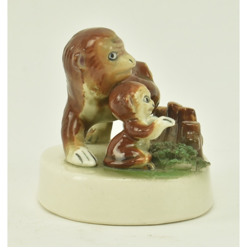 8 - A Staffordshire style ceramic scene depicting two monkeys, a mother and cub. The monkey cub with arm... 