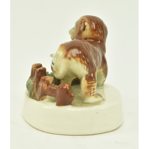 8 - A Staffordshire style ceramic scene depicting two monkeys, a mother and cub. The monkey cub with arm... 