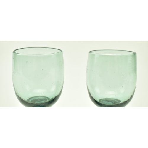 66 - A pair of late 18th century continental roemer drinking glass. Each glass having a bucket bowl above... 