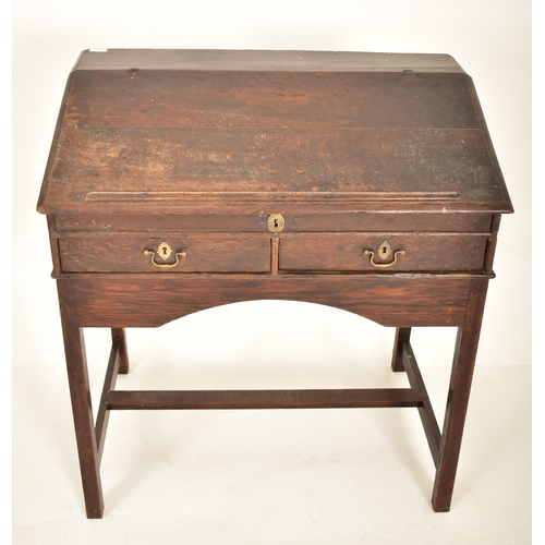 401 - An 18th century oak wood clerk's writing desk. The desk having a slope top with gallery front to hol... 