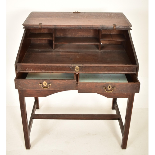 401 - An 18th century oak wood clerk's writing desk. The desk having a slope top with gallery front to hol... 