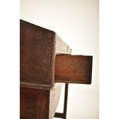 401 - An 18th century oak wood clerk's writing desk. The desk having a slope top with gallery front to hol... 