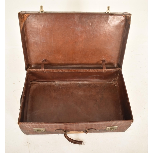 402 - A large early 20th century crocodile skin leather suitcase / travel case. The case with metal locks ... 