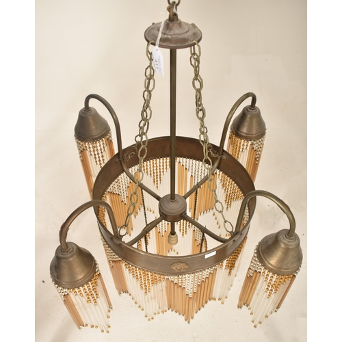 411 - An Art Deco inspired 20th century bronzed metal & glass rod four arm ceiling chandelier light. The c... 