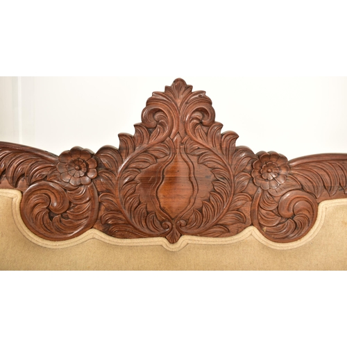 415 - A 19th century Anglo Colonial scroll ended chaise lounge / sofa settee. The chaise having a carved m... 