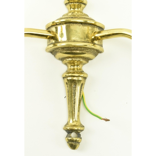 434 - A set of three Italian manner 20th century gilded metal twin arm wall sconces. Each light having a t... 