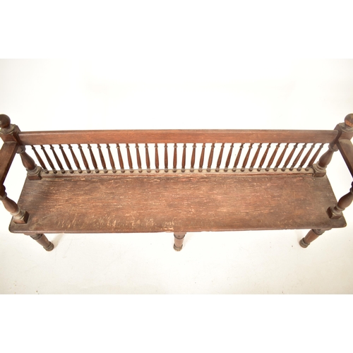 438 - A Victorian 19th century oak wood spindle back hall settle bench. The bench having block & turned ba... 