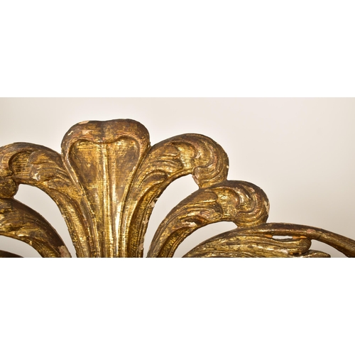 450 - A large continental 19th century Italian Rococo inspired gilt wood wall mirror. The mirror having an... 