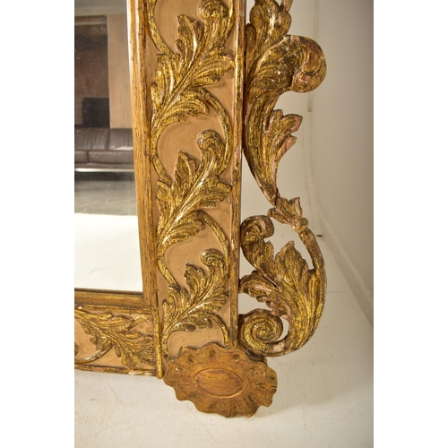 450 - A large continental 19th century Italian Rococo inspired gilt wood wall mirror. The mirror having an... 