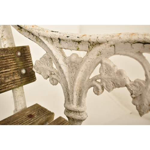 454 - A 19th century Victorian cast iron garden bench. The bench having cast iron sides with scrolled and ... 