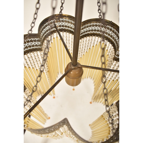 461 - An Art Deco inspired 20th century brassed metal & glass rod ceiling chandelier light. The chandelier... 