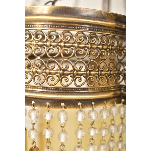 461 - An Art Deco inspired 20th century brassed metal & glass rod ceiling chandelier light. The chandelier... 