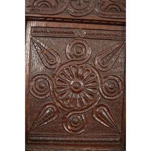 474 - A 19th century Victorian Gothic carved oak settle / bench. The settle having an intricately carved b... 