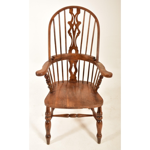 482 - A late Victorian late 19th century beech & elm comb back Windsor armchair. The chair having a comb t... 