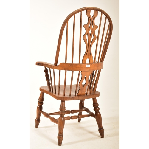 482 - A late Victorian late 19th century beech & elm comb back Windsor armchair. The chair having a comb t... 