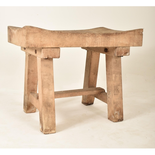 306 - A late 19th century / early 20th century beech butcher's block. The table having a squared concave t... 