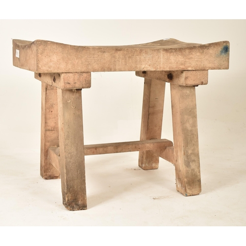 306 - A late 19th century / early 20th century beech butcher's block. The table having a squared concave t... 