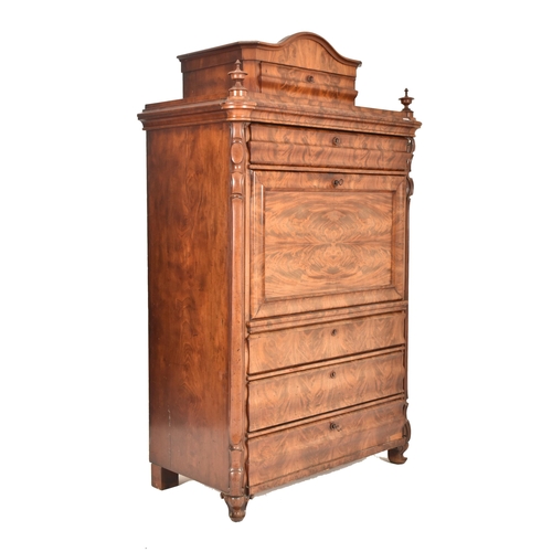 312 - A 19th century Biedermeier walnut secretaire bureau Abattant. The secretaire having a bowed top pedi... 