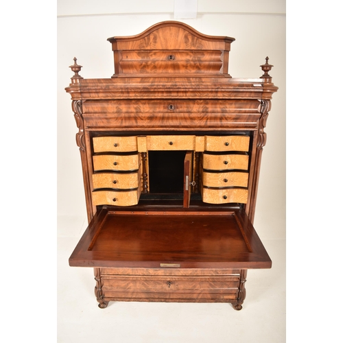 312 - A 19th century Biedermeier walnut secretaire bureau Abattant. The secretaire having a bowed top pedi... 