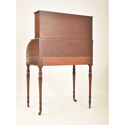 316 - A 19th century Victorian mahogany cylinder bureau desk. The bureau having a cabinet top with central... 